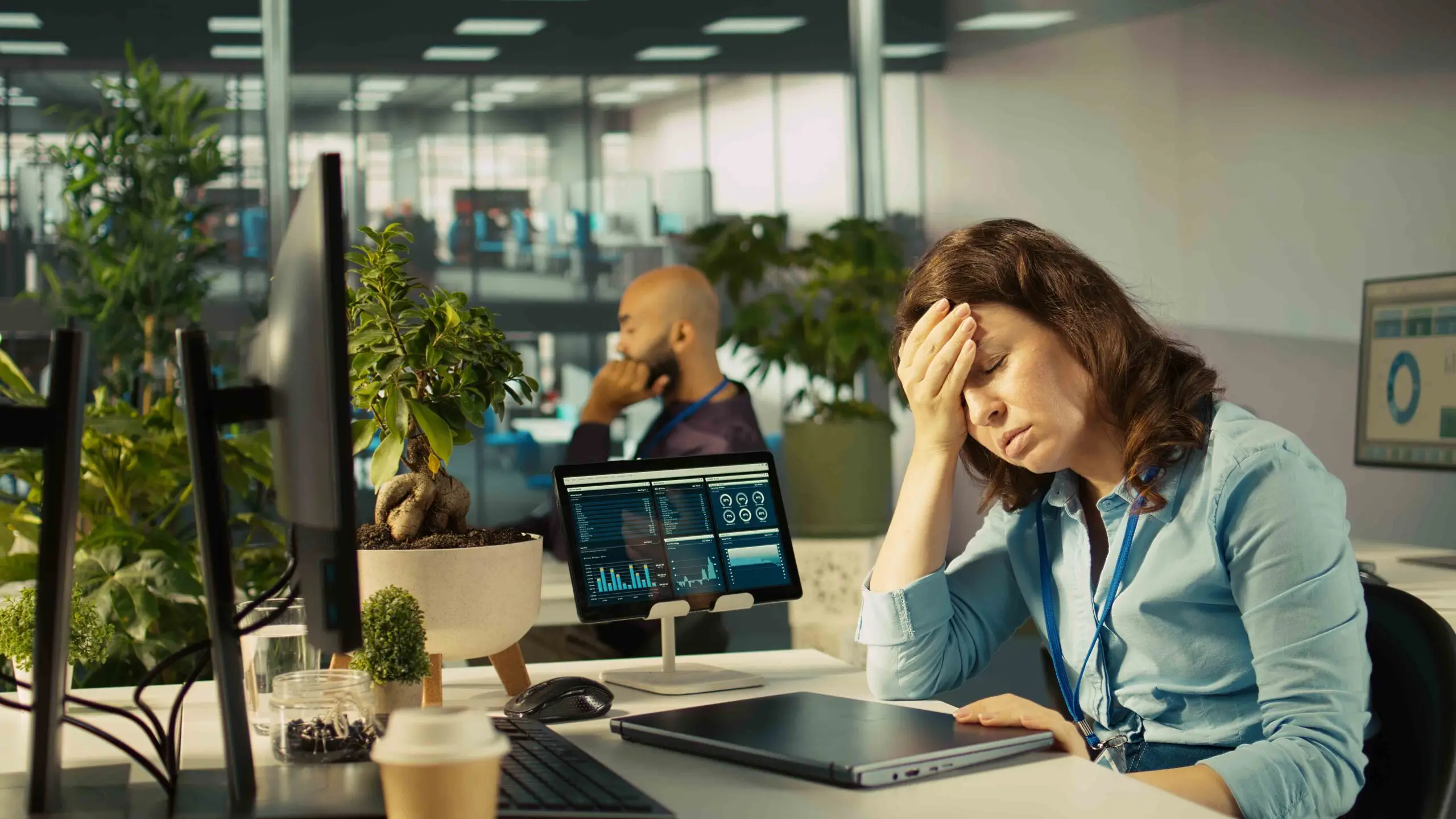 Accountant in busy modern startup agency imputing financial figures on PC