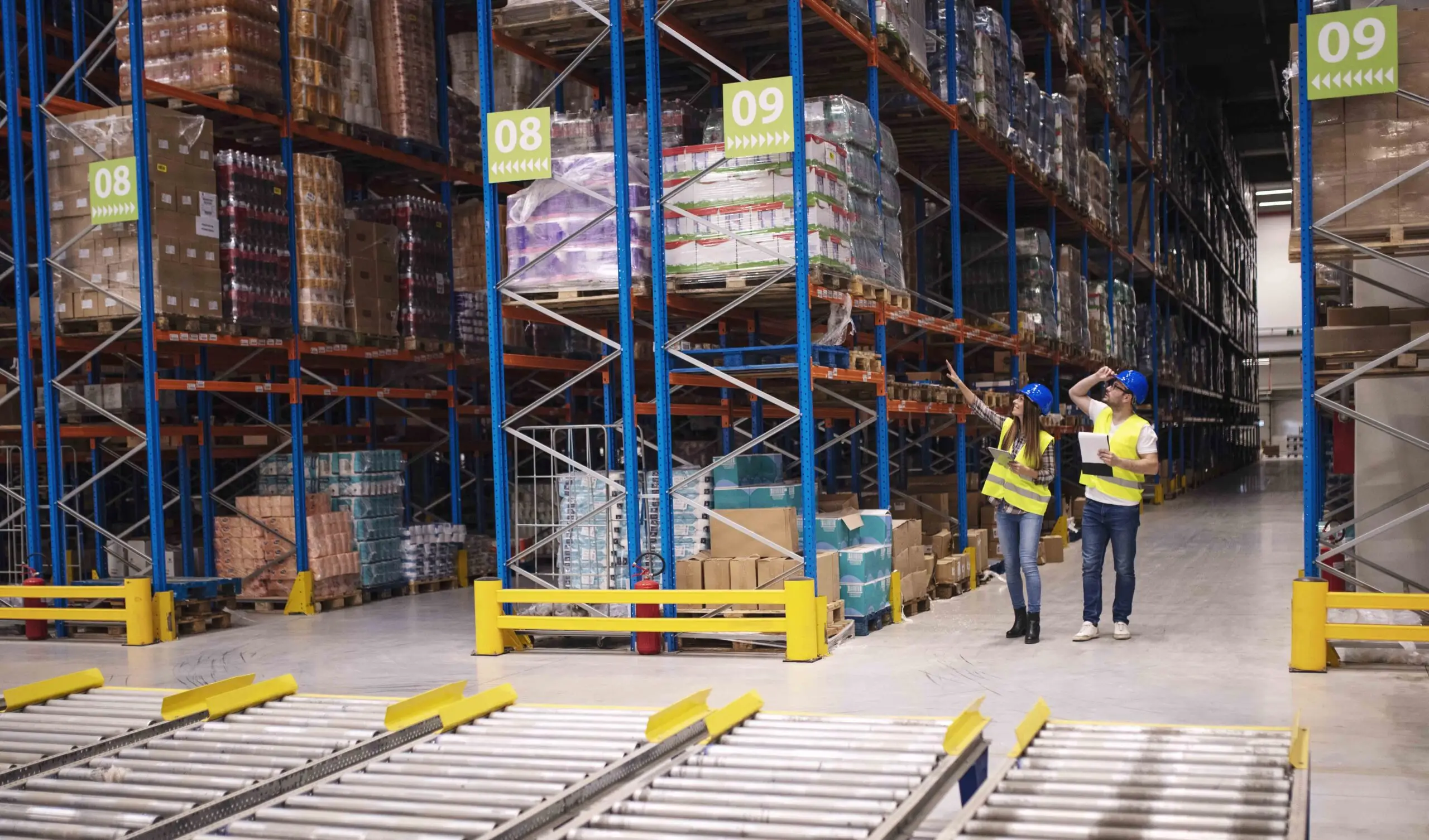Warehouse workers checking inventory and goods distribution in l